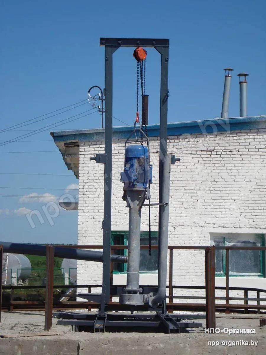 A pump on a portal with a chain hoist and an outlet into the pressure pipeline